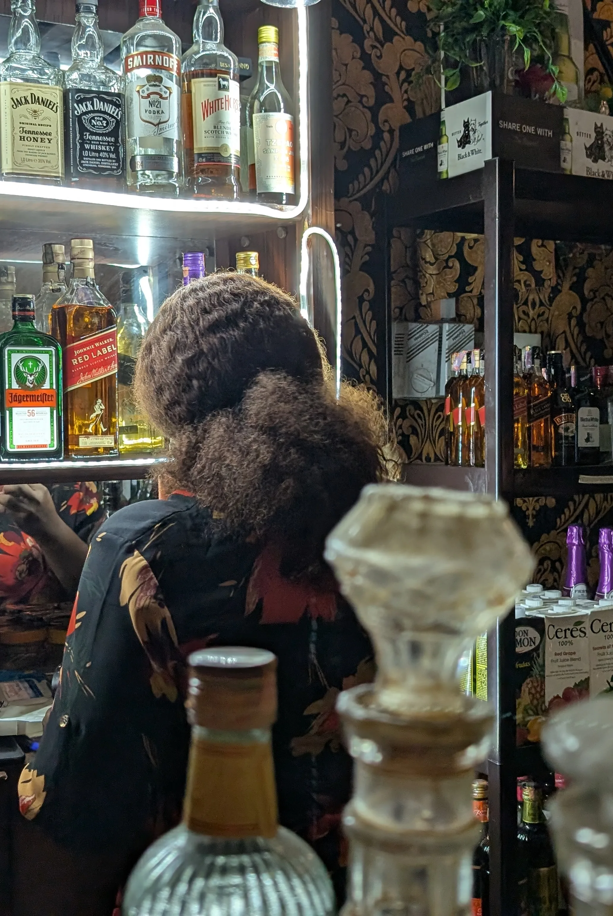 Bar lady serving cocktails at a vibrant bar